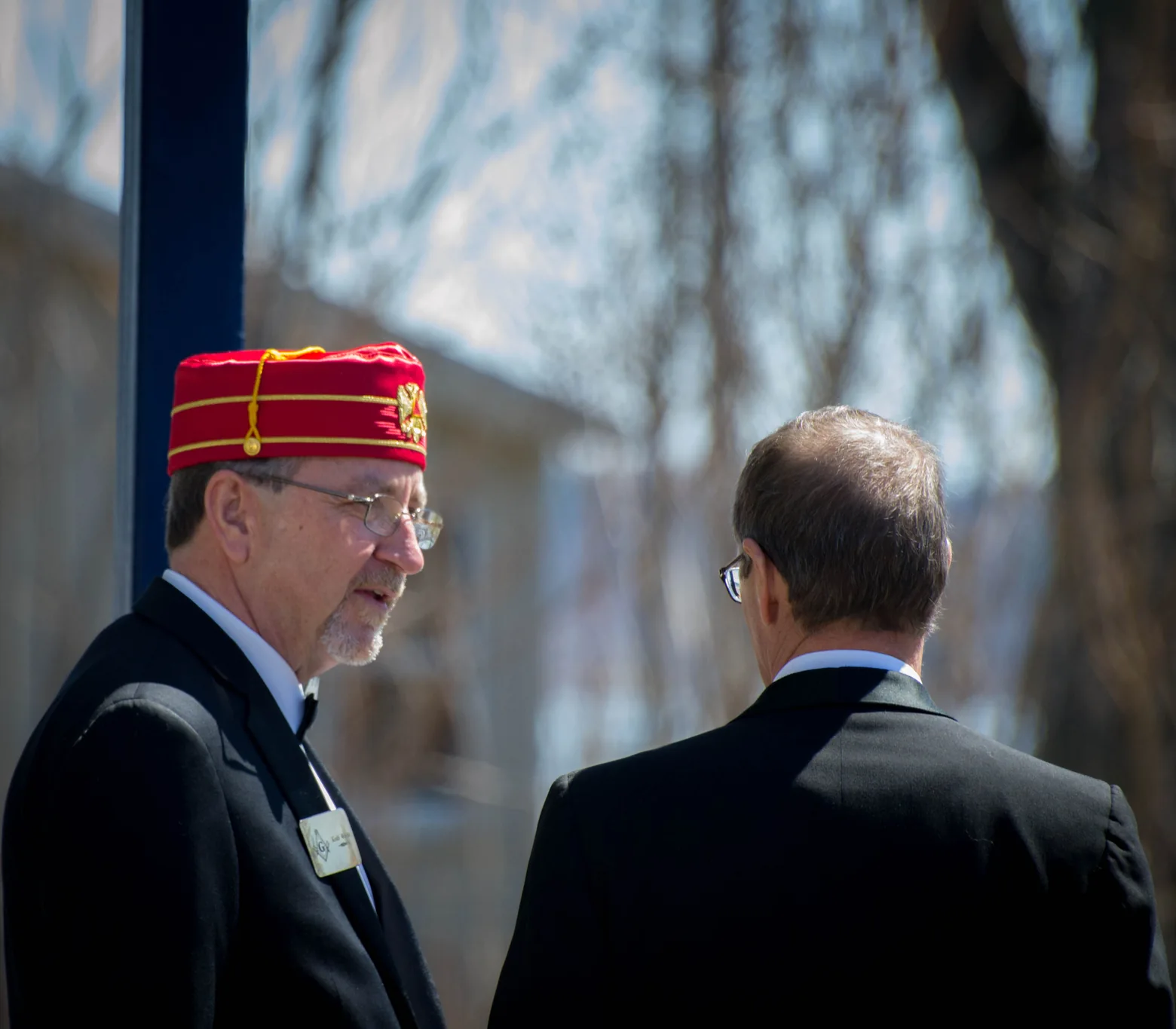 Two men greeting one another outdoors