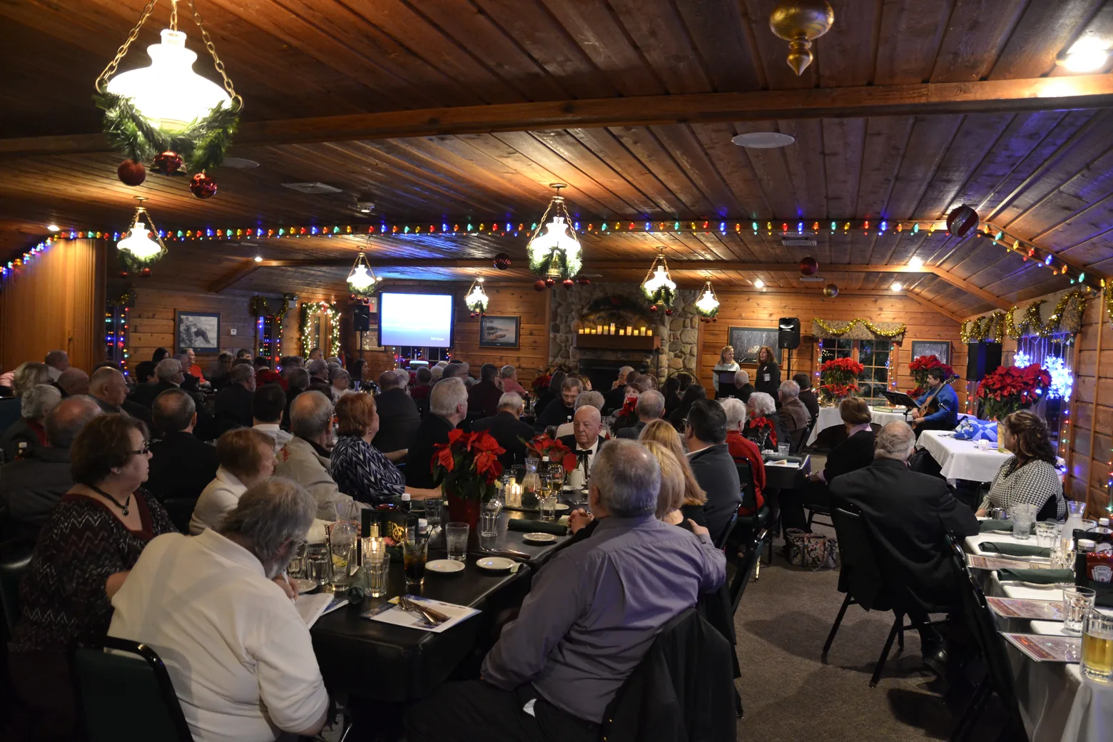 People gathered around tables in a lodge room